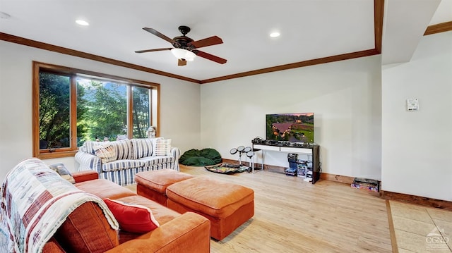 living room featuring hardwood / wood-style flooring, ceiling fan, and crown molding