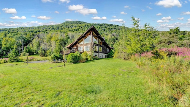 exterior space featuring a lawn and a mountain view