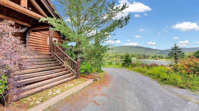 exterior space with a water and mountain view