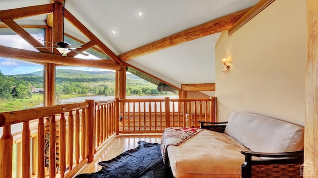 living area featuring ceiling fan, beam ceiling, wood-type flooring, and high vaulted ceiling