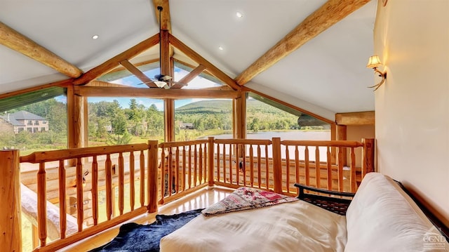 interior space with vaulted ceiling with beams, ceiling fan, and a wealth of natural light