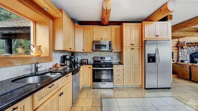 kitchen with sink, tasteful backsplash, beamed ceiling, light brown cabinetry, and appliances with stainless steel finishes