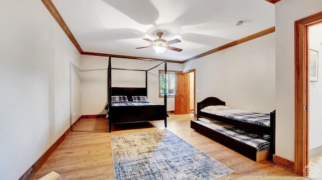 bedroom featuring ceiling fan, light hardwood / wood-style floors, and ornamental molding