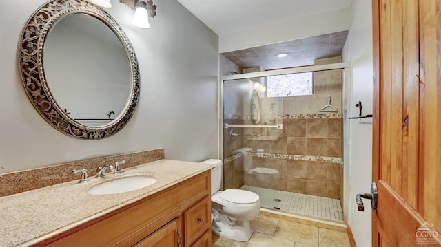 bathroom featuring vanity, toilet, and a shower with door