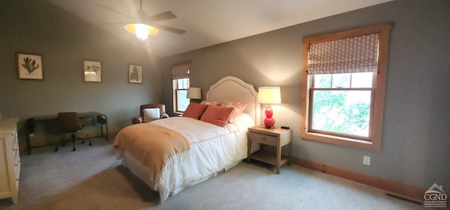 bedroom with multiple windows, light carpet, and ceiling fan