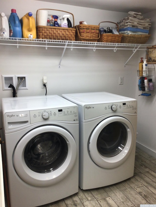 laundry area featuring light wood-style floors, laundry area, and separate washer and dryer