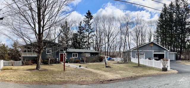 view of front of property featuring an outbuilding, a front yard, and fence