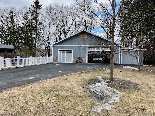 detached garage featuring fence