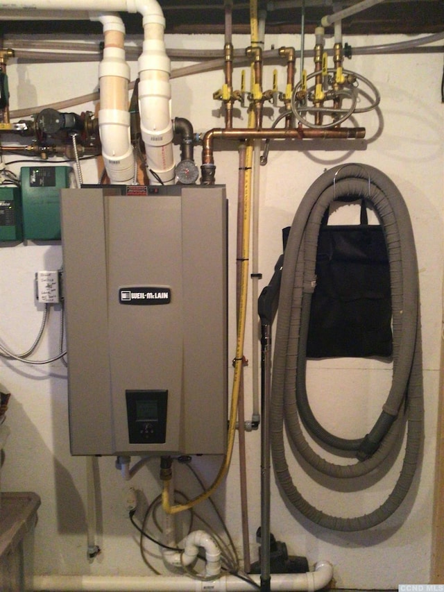 utility room featuring water heater