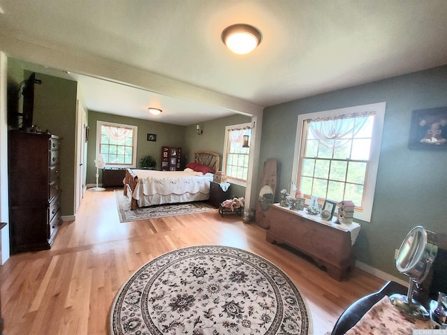 bedroom featuring wood finished floors and baseboards