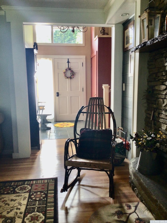 foyer entrance featuring ornamental molding and wood finished floors