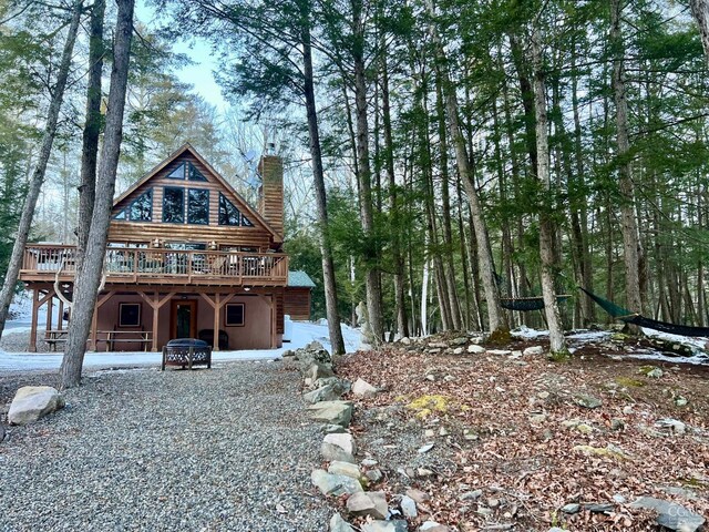 rear view of house featuring a deck