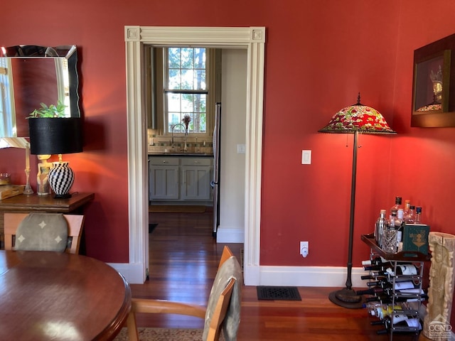 dining area with sink and hardwood / wood-style flooring