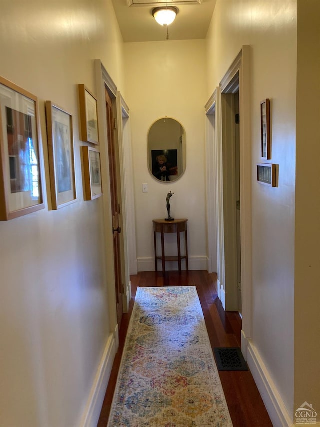 hall with dark wood-type flooring