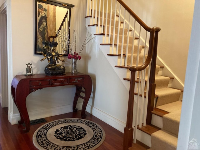 staircase with hardwood / wood-style floors