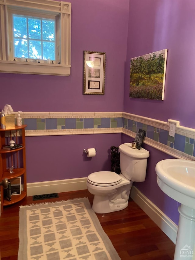 bathroom with hardwood / wood-style floors and toilet