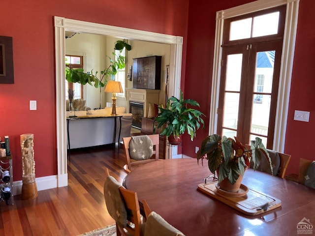 dining space with a healthy amount of sunlight and dark hardwood / wood-style flooring