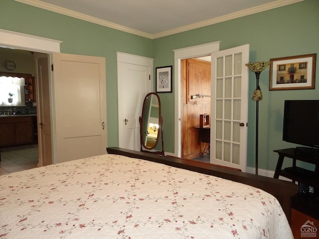 bedroom featuring ensuite bathroom and crown molding