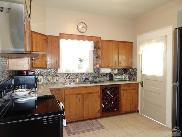 kitchen featuring backsplash, black range with electric stovetop, sink, light tile patterned floors, and range hood