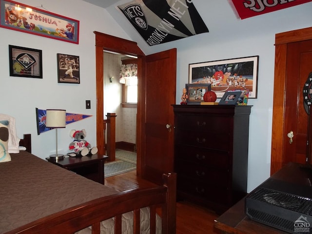 bedroom with hardwood / wood-style floors and vaulted ceiling