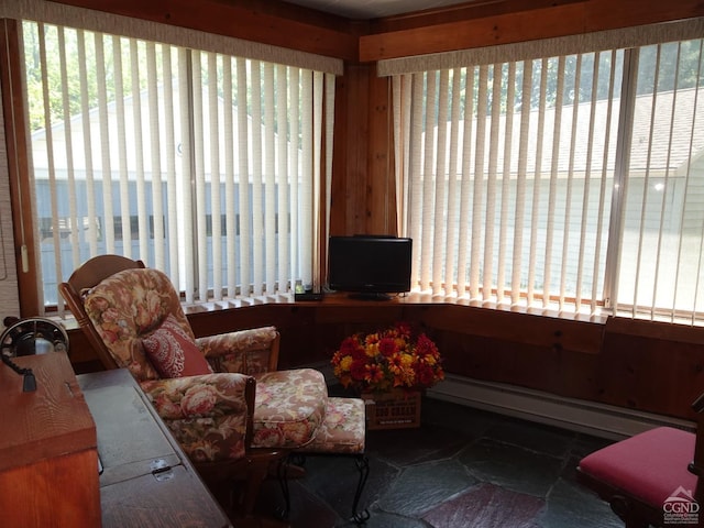 living area with a baseboard heating unit