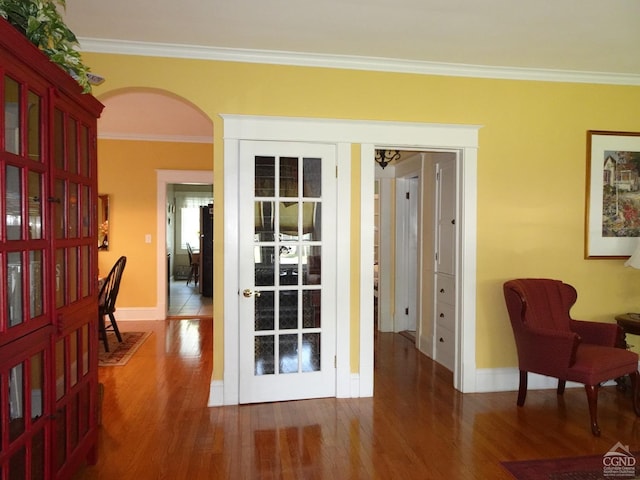 entryway with hardwood / wood-style floors, french doors, and ornamental molding