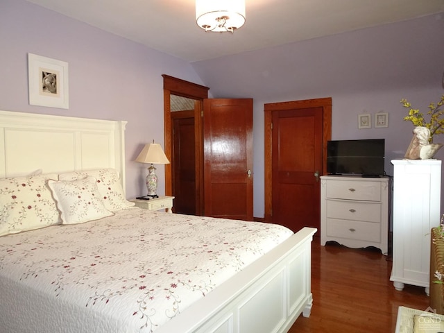 bedroom featuring dark hardwood / wood-style floors and lofted ceiling