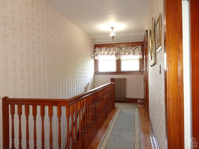 hallway with tile patterned floors and radiator heating unit