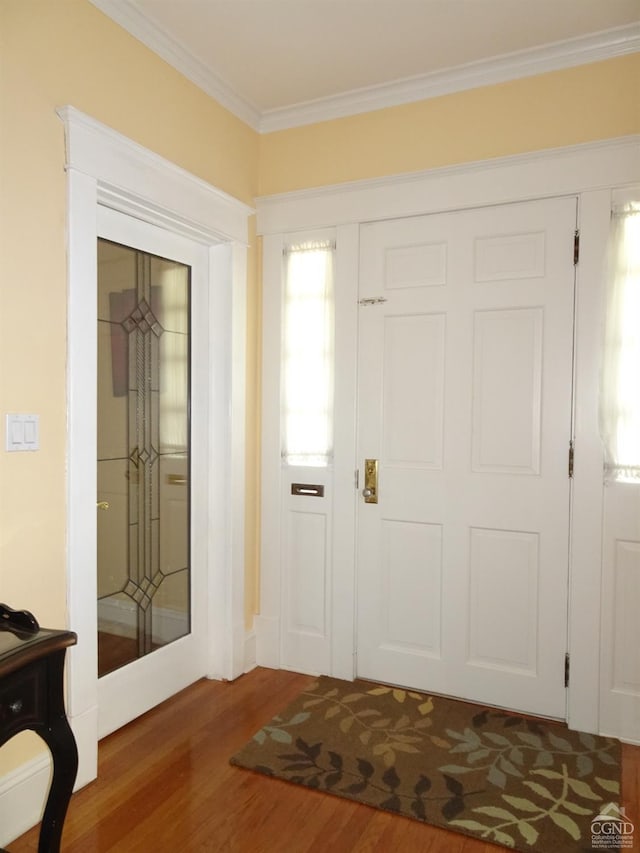 entrance foyer with dark wood-type flooring and ornamental molding