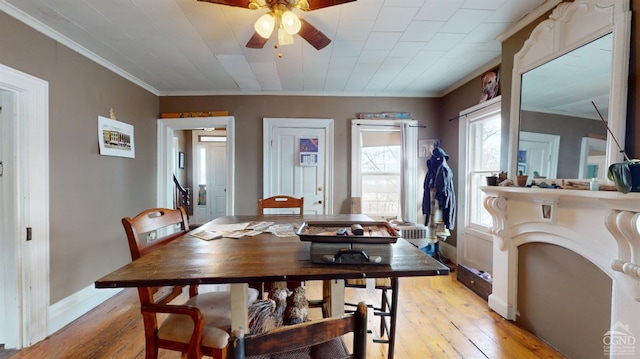 dining space featuring ornamental molding, light hardwood / wood-style floors, and ceiling fan