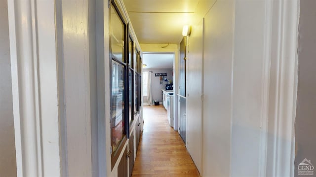 hallway with light hardwood / wood-style floors