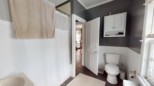 bathroom featuring crown molding, plenty of natural light, toilet, and hardwood / wood-style floors