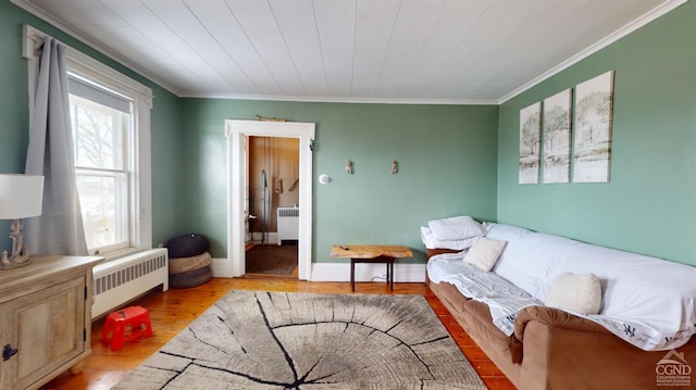 sitting room with radiator, a wealth of natural light, and light wood-type flooring