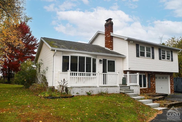 view of front of property featuring a garage and a front lawn