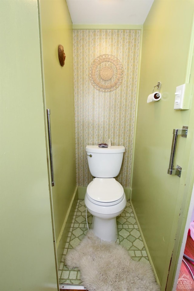 bathroom with tile patterned flooring and toilet