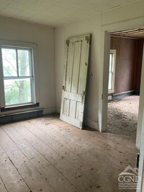 empty room with light hardwood / wood-style flooring