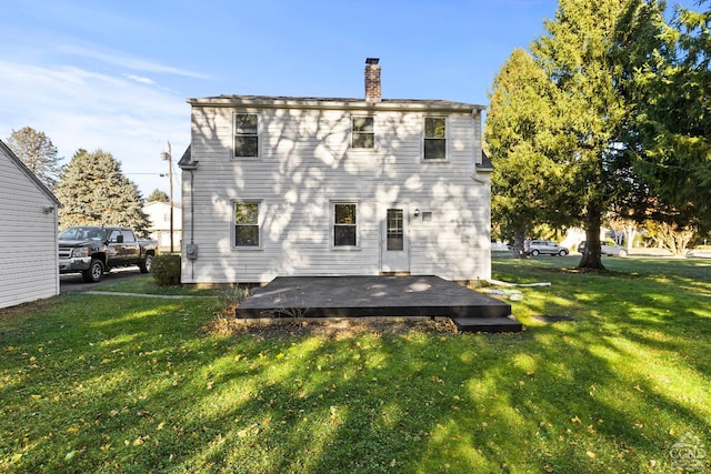 rear view of house featuring a lawn