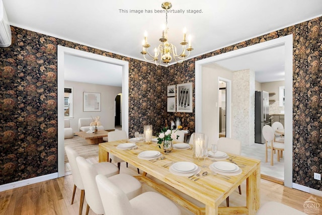 dining room featuring an inviting chandelier and light wood-type flooring