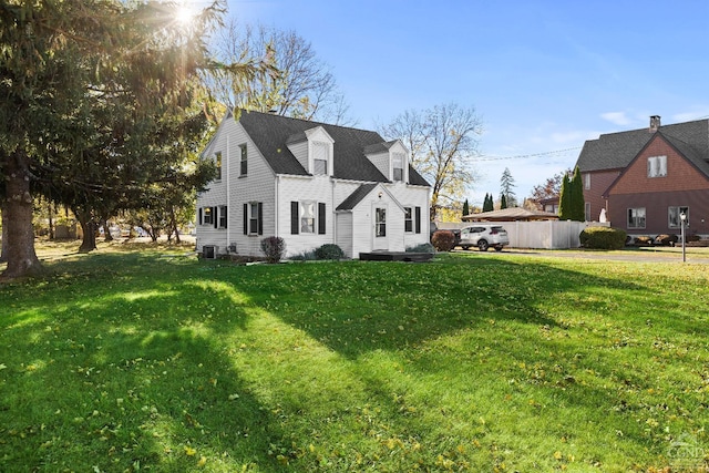 view of property exterior with a lawn and central AC unit