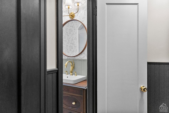 bathroom with vanity and wooden walls