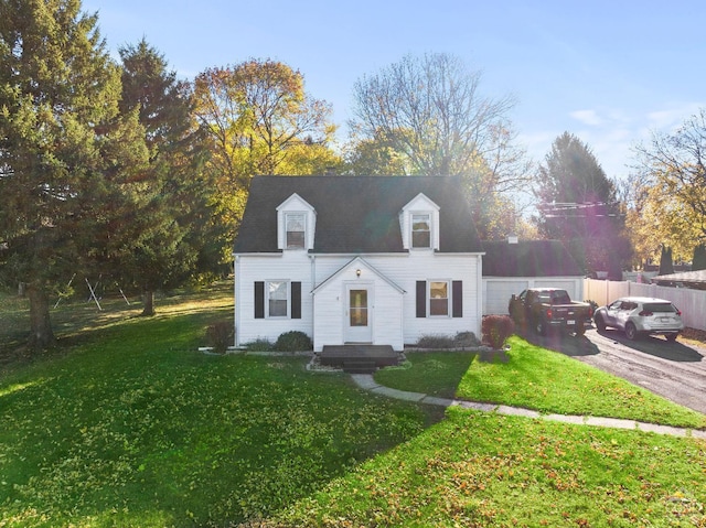 cape cod-style house featuring driveway, a garage, fence, and a front lawn