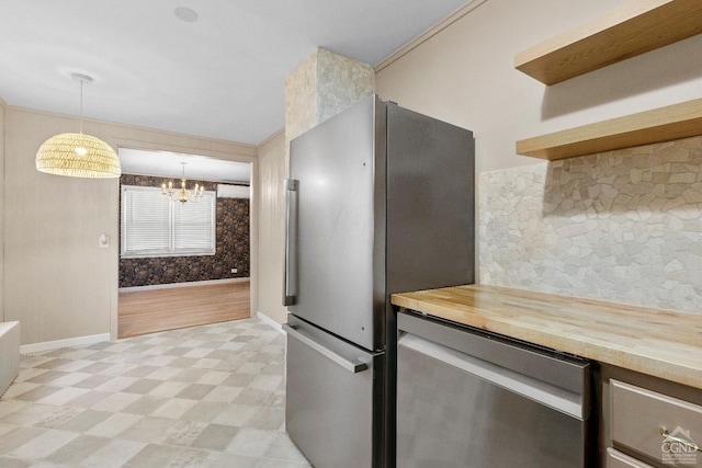 kitchen with decorative light fixtures, stainless steel appliances, and a chandelier