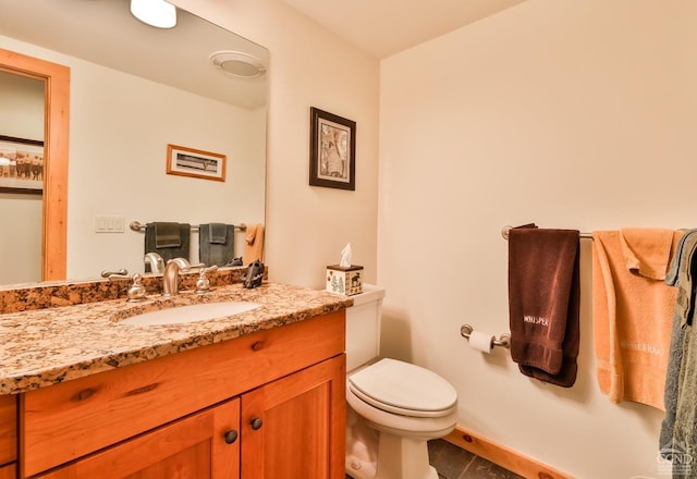 bathroom featuring vanity and toilet