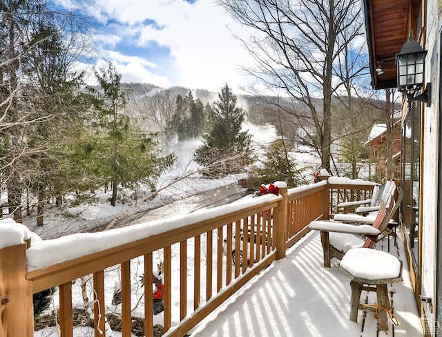 view of snow covered back of property