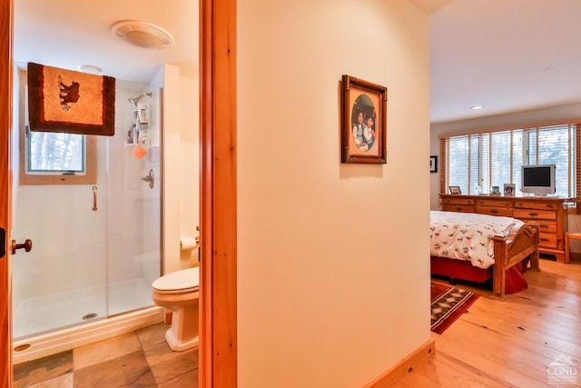 hall featuring light wood-type flooring and a wealth of natural light