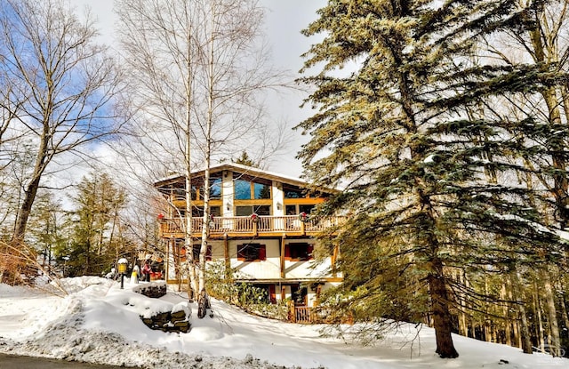 view of snow covered back of property