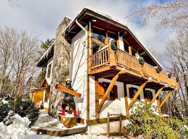 view of snowy exterior with a deck