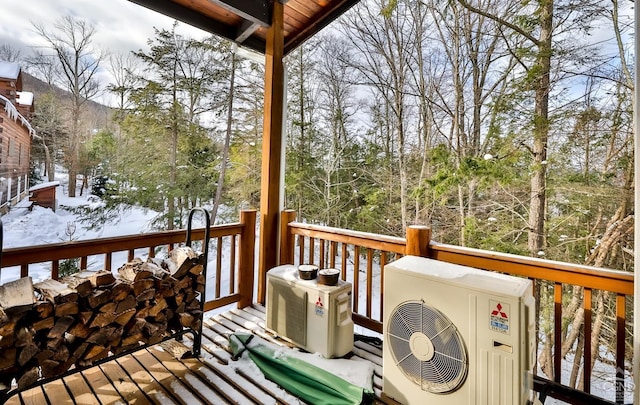 snow covered deck featuring ac unit