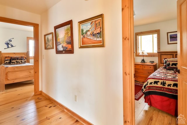 corridor with light hardwood / wood-style flooring