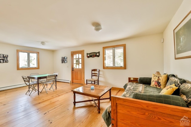 living room with a baseboard radiator and light wood-type flooring